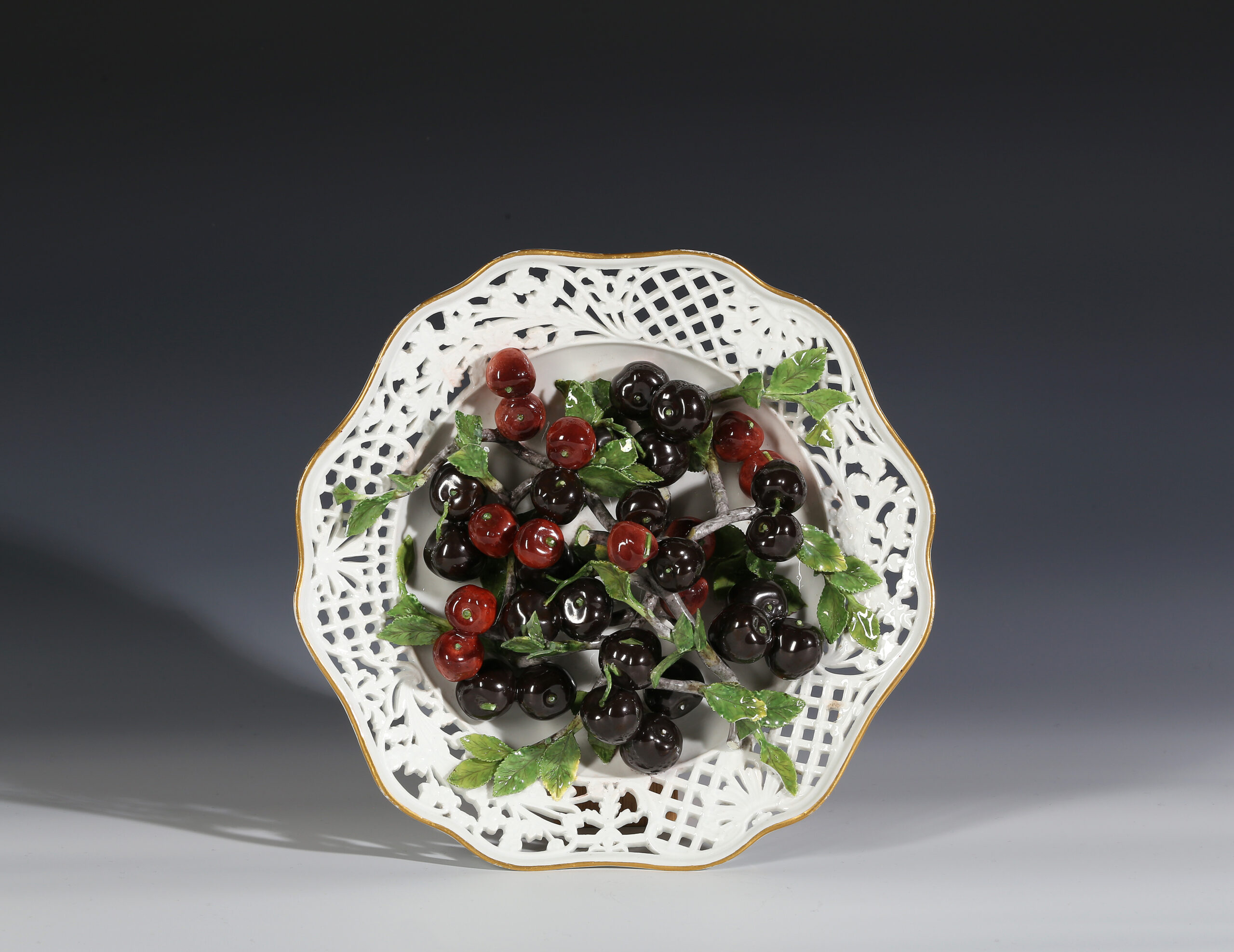A MEISSEN DESSERT PLATE OF CHERRIES  from the  ‘BRÜHLSCHE ALLERLEI’ SERVICE